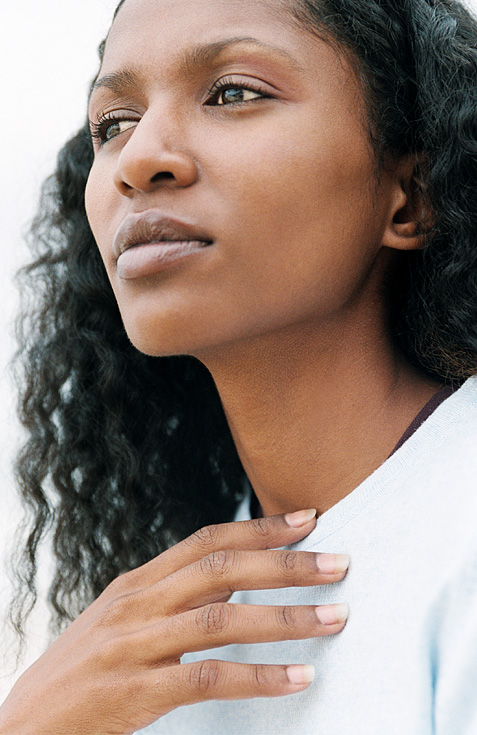 Image of woman holding chest.